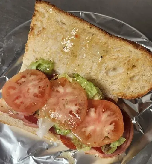 Italian Combo Sub - Handcrafted Bread, Canadian Bacon, Pepperoni, Onion, Provolone Cheese, Lettuce, Tomatoes & Italian Dressing