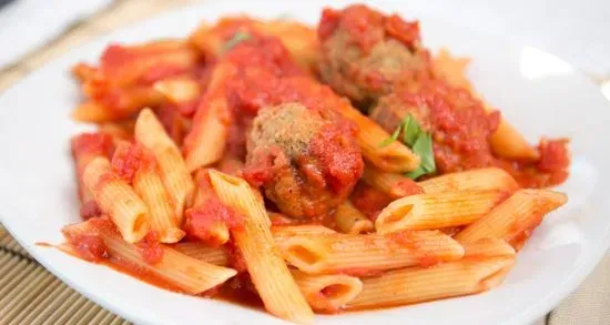 Meatballs Over spaghetti in red sauce 