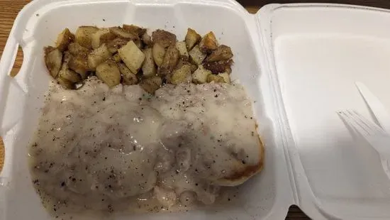 Sausage Gravy Over Buttermilk Biscuits served with home fries..