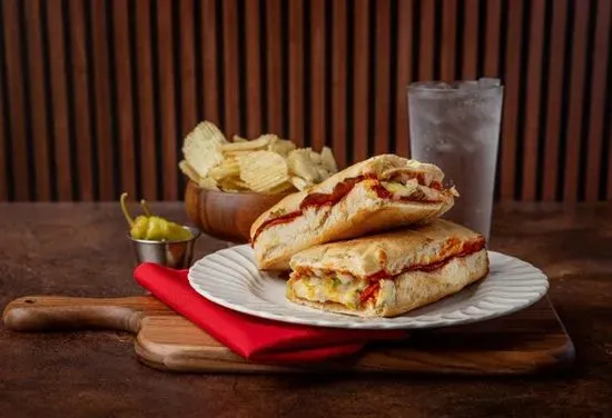 Stromboli (Sausage, Chopped Pepperoncini, Onions, Green Pepper, Pepperoni, Mozzarella & Provolone), chips, and a pepperoncini pepper Kids Menu