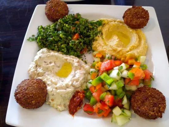 Mediterranean Veggie Plate -   Grilled veggies, hummus, flavorful falafel, creamy baba ganoush, fresh tabbouleh salad, paired with soft pita bread.