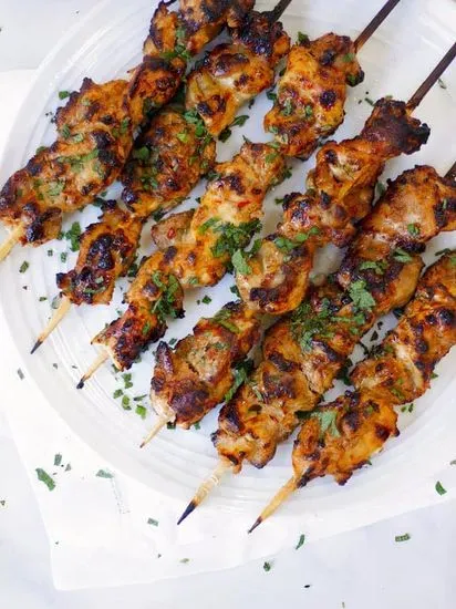 Chicken Kabab Plate - Grilled chicken marinated in Mediterranean spice with rice, served with  grilled tomato, grilled onion, hummus, nutty tahini, and a refreshing salad. 